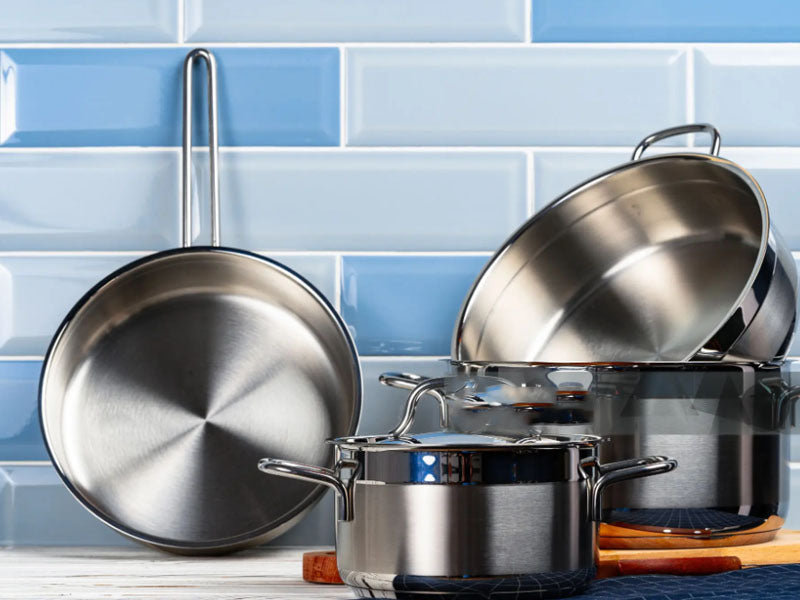Layered clad stainless steel cookware construction and finished cookware