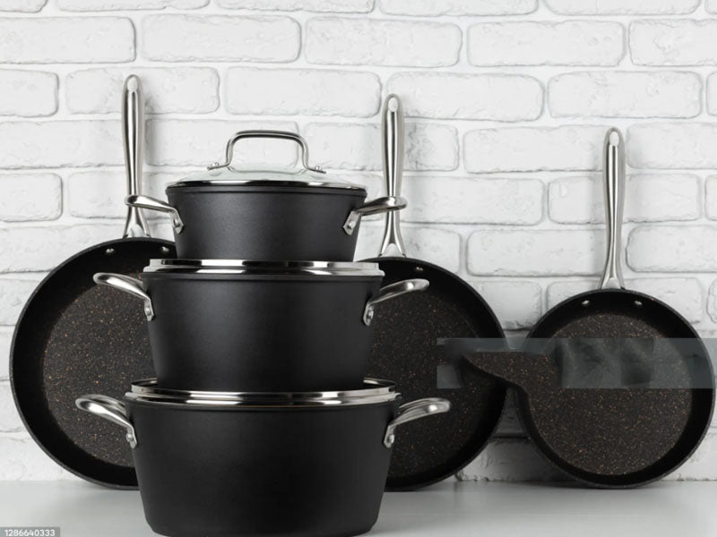 Dark hard-anodized aluminum cookware and surface details